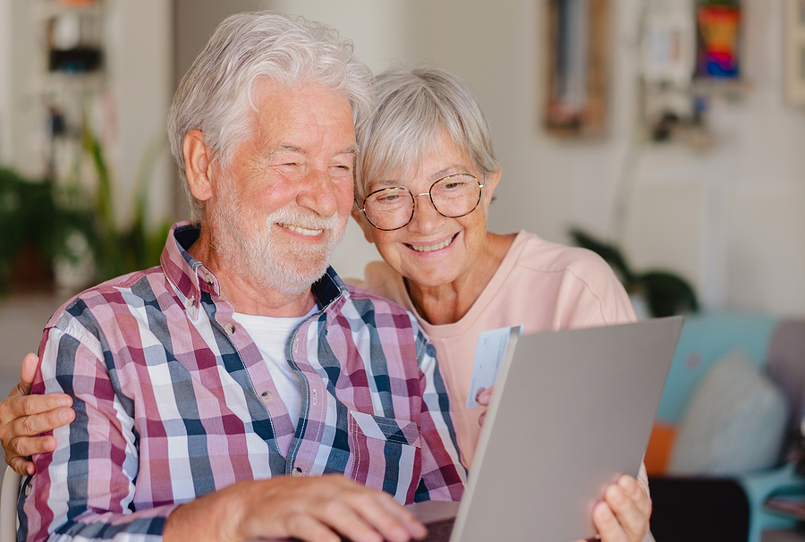 Portrait Of Happy Modern Elderly Couple Browsing Together On Laptop Portrait Of Happy Modern Elderly Couple Browsing Together On Laptop