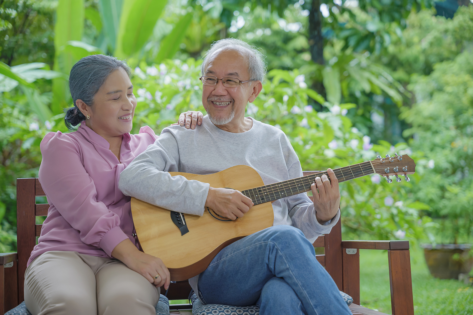 Happy Asian Senior Couple Elderly Man Playing Guitar While His W