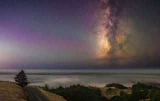 The image depicts a serene, starry night sky with a lone tree on a hill, under a beautiful purple and pink twilight sky.