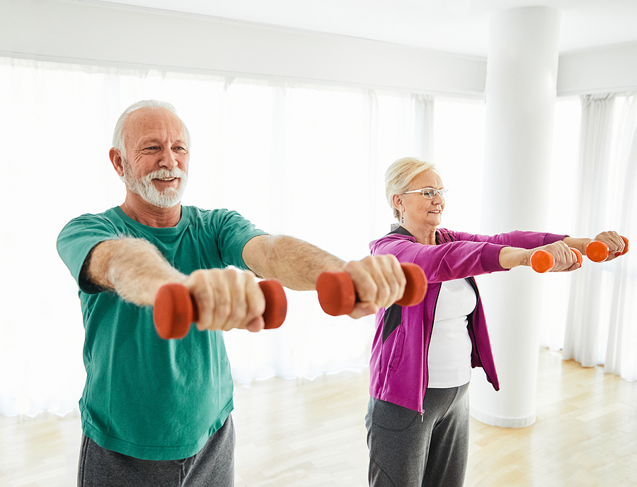 Senior Couple Exercise Stretching And Exercising With Dumbbell L