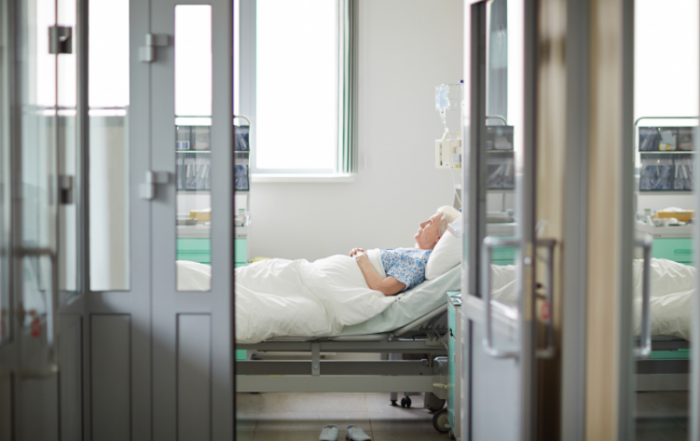 Patient laying in hospital bed.