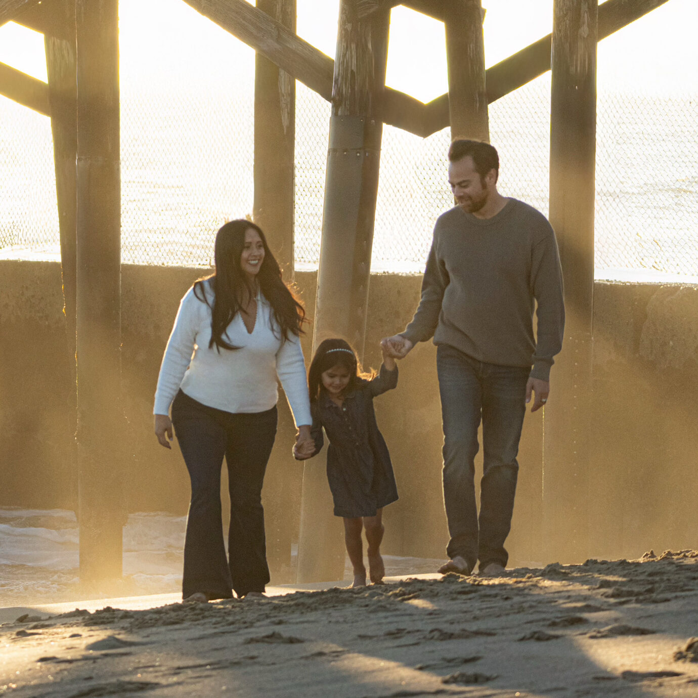 Briones & Gjellstad Family Photo of Aaron, JamieRose and Naomi holding hands on a beach